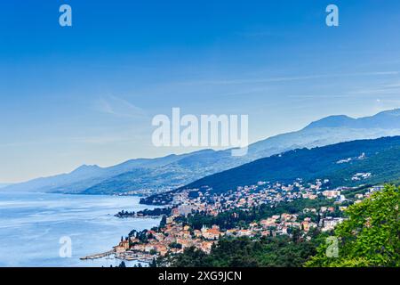 Ein Panoramablick auf Opatija, Kroatien, mit Blick auf die Stadt eingebettet zwischen der Adria und einer üppigen, bewaldeten Bergkette. Stockfoto