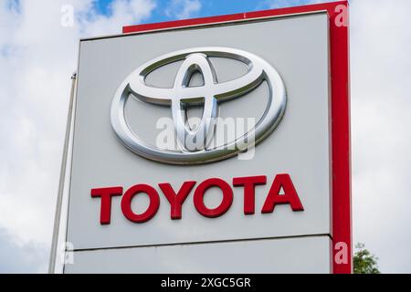 Telford, Großbritannien - 8. Juli 2024: Logo und Name des Motorunternehmens Toyota außerhalb eines Ausstellungsraums eines Autohändlers Stockfoto