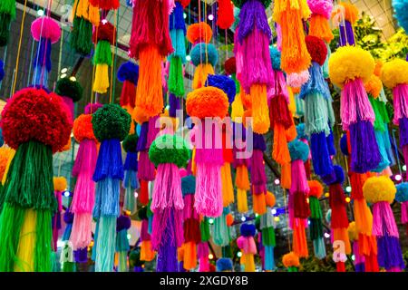 Decorations hanging colored jellyfish made from woolen threads and pompom balls suspended on the ceiling. Stockfoto
