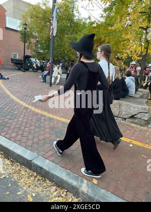 Zwei Freunde spazieren durch die Innenstadt von Salem Massachusetts während eines Halloween-Festivals an einem Herbsttag in Salem Massachusetts Stockfoto