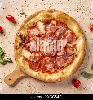 Runde, gekochte Pizza mit Peperoni und Schinken auf einem Pizzastein, fertig zum Servieren Stockfoto