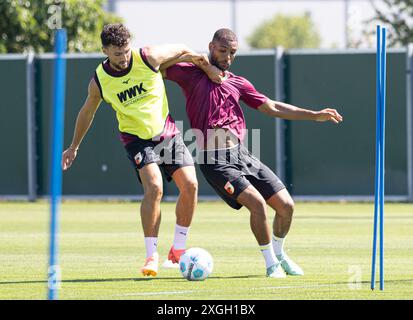 Kampf um den Ball zwischen Maximilian Bauer (FC Augsburg #23) und Neuzugang Steve Mounié (FC Augsburg, re.); FC Augsburg, Training, Stockfoto