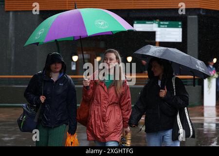 Juli 2024; All England Lawn Tennis and Croquet Club, London, England; Wimbledon Tennis Tournament, Tag 9; Zuschauer in Wimbledon versuchen, unter dem starken Regen trocken zu bleiben Stockfoto