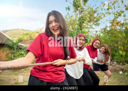 Porträt einer indonesischen Frau feiert den Indonesien Unabhängigkeitstag mit traditionellen Veranstaltungen wie einem Tauziehen im Freien Stockfoto