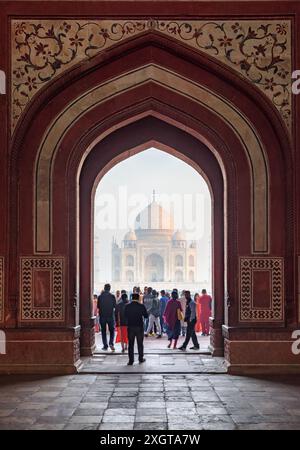 Agra, Indien - 8. November 2018: Fantastischer Blick am frühen Morgen auf das Taj Mahal durch den bogenförmigen Eingang zu den Gärten des Komplexes. Stockfoto
