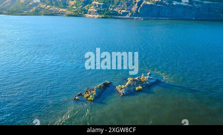 Fliegen Sie durch die Rocky Inselchen und Klippen in ruhigem Wasser Stockfoto