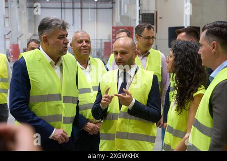 Popesti-Leordeni, Rumänien. 10. Juli 2024: Radu Berevoescu (C), General Manager und Senior Commercial Director PepsiCo East Balkans, spricht mit Marcel Ciolacu (L), dem rumänischen Premierminister, während der Eröffnung des automatisierten PepsiCo-Lagers, einer Veranstaltung, die den Abschluss eines Investitionsprojekts im Wert von über 100 Millionen Dollar markiert. Quelle: Lucian Alecu/Alamy Live News Stockfoto