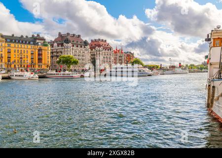 Farbenfrohe Gebäude entlang der Strandvagen Straße mit Booten entlang des Yachthafens im Stadtzentrum von Stockholm, Schweden. Stockfoto