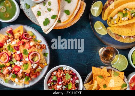 Mexikanischer Esshintergrund mit einem Platz für Text. Nachos mit Rindfleisch, Gemüsetacos, Quesadillas, Tequila, eine Designvorlage für ein Menü, auf einem dunkelblauen Stockfoto