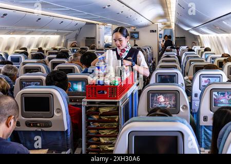 Kabinenbesatzung und Passagiere, die auf einem Flug von Bangkok nach Manila mit Philippine Airlines fliegen Stockfoto