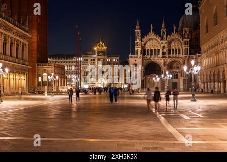 Piazza San Marco bei Nacht in der Stadt Venedig, Italien. Markusdom und Uhrenturm Torre dell'Orologio am Hauptplatz im San Marco Viertel. Stockfoto