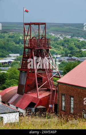 Das gewundene Zahnrad im Big Pit National Mining Museum of Wales mit der Stadt Blaenafon im Hintergrund, Blaenafon, South Wales Stockfoto