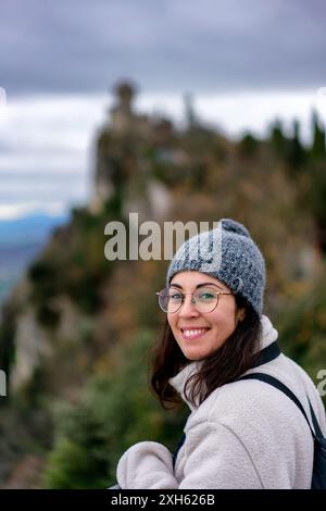 Woman smiling at the camera with San Marino castle on the background Stock Photo