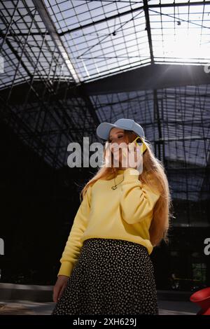 Ukrainian woman talking on the phone in a glass building Stock Photo