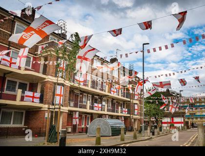 Bermondsey, London, 12. Juli 2024. Das Kirby Estate in Bermondsey, bekannt für seine farbenfrohen Flaggendekorationen für Fußballspiele Englands, ist wieder einmal mit mehreren hundert Flaggen auf dem patriotischen Anwesen, sowie dem kürzlich enthüllten Wandgemälde von Eberechi Eze und anderen farbenfrohen Wandgemälden in den Rillen, vor dem Finale der Fußball-Europameisterschaft England gegen Spanien am Sonntag. Quelle: Imageplotter/Alamy Live News Stockfoto