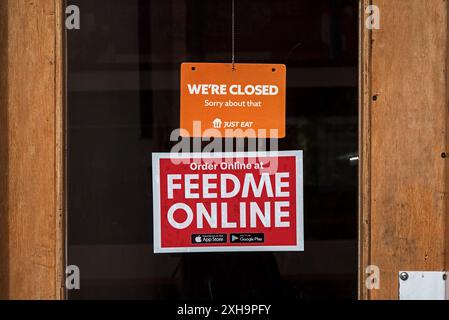 Wir sind geschlossen an der Tür eines Cafés mit einem Feed Me Online-Schild unten in Edinburgh, Schottland, Großbritannien. Stockfoto