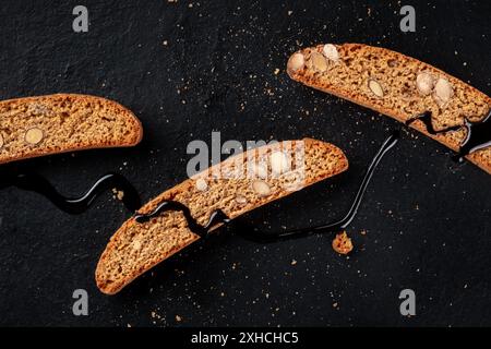 Cantucci Nahaufnahme. Traditionelle italienische Mandelkekse, von oben nach unten gedreht auf schwarzem Hintergrund Stockfoto