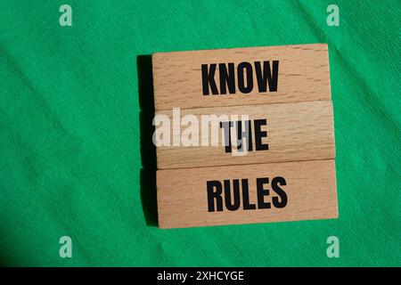 Kennen Sie die Regeln, die auf Holzblöcken mit grünem Hintergrund geschrieben sind. Das Symbol Regeln kennen. Kopierbereich. Stockfoto
