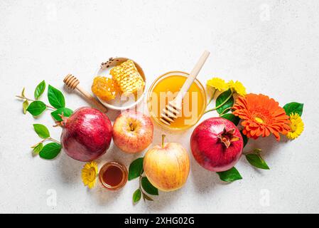 Rosh Haschana. Granatapfel, Äpfel und Honig traditionelle Symbole für die Feier auf weißgrauem Hintergrund. Jüdische Herbsternte Rosch Hashana celebrati Stockfoto