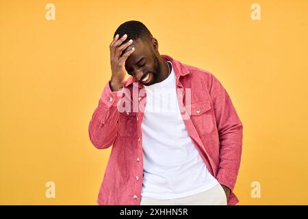 Glücklicher, fröhlicher, cooler Gen z Schwarzer Hipster-Typ, der an der gelben Wand steht. Offen. Stockfoto
