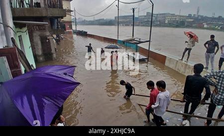 Mumbai, Indien. Juli 2024. MUMBAI, INDIEN - 14. JULI: Aufgrund von starkem Regen ist der Fluss Kamvari in der Nähe des Dorfes Shelar in Bhiwandi überschwemmt und Wasser ist in die Häuser der Bewohner des Slumgebiets an der Flussseite eingedrungen, am 14. Juli 2024 in Mumbai, Indien. (Foto: Praful Gangurde/Hindustan Times/SIPA USA) Credit: SIPA USA/Alamy Live News Stockfoto