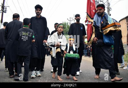 Srinagar, Indien. Juli 2024. Kaschmirkinder laufen barfuß während der 7. Muharram-Prozession in Rainawari, Srinagar. Muharram ist der erste Monat des islamischen Mondkalenders und gilt als einer der heiligsten Monate im Islam. (Foto von Danish Showkat/SIPA USA) Credit: SIPA USA/Alamy Live News Stockfoto