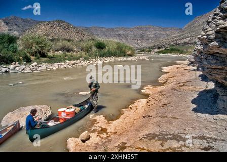 Kanufahrer am Flussufer des Rio Grande, in den unteren Schluchten des Rio Grande, in der Black Gap Wildlife Management Area, fahren den Rio Grande, Texas, USA hinunter Stockfoto