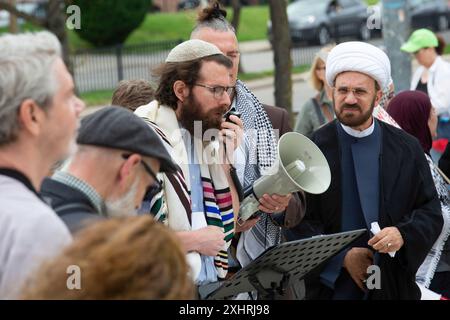 Detroit, Michigan, USA. Juli 2024. Interreligiöse Führer versammelten sich an der Wayne State University, um sich zu versammeln und für Frieden in Gaza zu beten. Sie baten die Universität, sich von Unternehmen zu veräußern, die von Krieg und Waffenherstellung profitieren. Die Universität schaltete Rasensprenger rund um Spirit Rock ein, wo sie sich sammeln wollten. Spirit Rock war der Ort eines Antikriegslagers für Studenten, das die Universitätspolizei im Mai abbrach. Quelle: Jim West/Alamy Live News Stockfoto