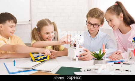 Kinder arbeiten zusammen an einem Robotik-Projekt in einem Klassenzimmer Stockfoto