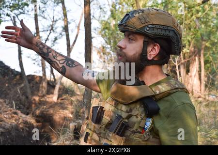15. Juli 2024, Robotyne, Zaporischschschhia, Ukraine: Ein ukrainischer Soldat der 65. Separaten Mechanisierten Brigade spricht über die Situation auf dem Schlachtfeld an der Frontlinie bei Robotyne. Der unnachgiebige Druck der Ukraine, ihre Verbündeten dazu zu bewegen, Ziele innerhalb Russlands mit gespendeten Waffen zu treffen, könnte beginnen zu funktionieren, sagte Präsident Wolodymyr Zelenskij am 15. Juli 2024. Wenn diese Erlaubnis nicht erlaubt wird, wird die Ukraine ihre eigenen Waffen einsetzen, um Russland zu treffen. Viele seiner Verbündeten unter der Führung der USA setzen den Zielen Grenzen, die sie innerhalb Russlands treffen können. Etwas, was Kiew sagt, macht Stockfoto