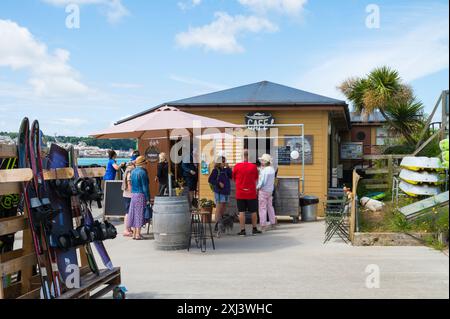 Gäste kaufen Erfrischungen im Camel Ski School Camel Ski Cafe Coffee Shop am Wasser in Rock, Cornwall, England, Großbritannien Stockfoto