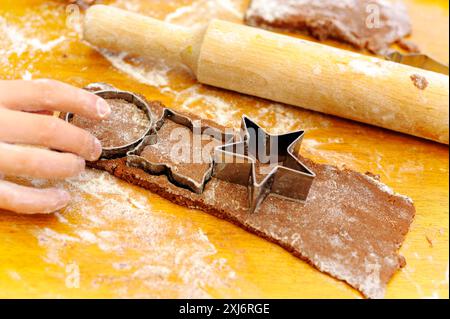 Schneiden von Formen aus dem Teig mit Keksschneider Stockfoto