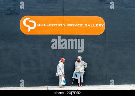Miami Florida America - 28. Juni 2012; zwei ältere schwarze Frauen stehen an der schwarzen Außenwand, während sie sich auf der Straße im Wynwood Arts District unterhalten. Stockfoto
