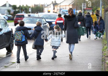 Aktenfoto vom 01/20 von Eltern, die mit ihren Kindern zur Schule in Hornchurch, Essex, gehen. Die Wohltätigkeitsorganisation Family Rights Group begrüßte 30 Millionen Pfund an Mitteln, die es etwa 1.000 Kindern in England ermöglichen werden, Unterstützungsnetzwerke über das Lifelong Links-Programm aufzubauen. wie sie sagten, wird zu vielen jungen Menschen, die in der Pflege sind, die Möglichkeit verwehrt, von Programmen zu profitieren, um sicherzustellen, dass sie das richtige Unterstützungsnetz um sie herum haben. Ausgabedatum: Mittwoch, 17. Juli 2024. Stockfoto