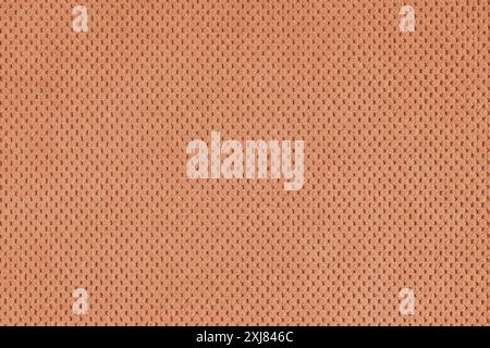 Einfarbiges, orangefarbenes Veloursmaterial, flauschiges Jacquard mit gemusterter Webstruktur im Hintergrund. Nahaufnahme, Textiloberfläche aus Makrogewebe. Hintergrundbild, Backdr Stockfoto