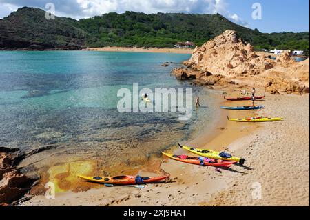 Kajaks landen auf einer Insel in der Bucht Cala Pregonda in der Nähe von Kap Cavalleria an der Nordküste von Menorca, Balearen, Spanien, Mittelmeer, Euro Stockfoto