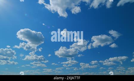 Zeitraffer. Wolken, die über den blauen Himmel laufen. Weiße, geschwollene und flauschige Wolken am blauen Himmel. Stockfoto