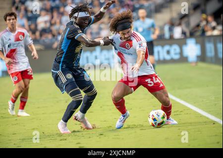 Chester, Pennsylvania, USA. Juli 2024. Philadelphia Union Spieler OLIVER MBAIZO (15) kämpft während des Spiels um den Ball gegen den New England Revolution Spieler RYAN SPAULDING (34) (Bild: © Ricky Fitchett/ZUMA Press Wire) NUR FÜR REDAKTIONELLE ZWECKE! Nicht für kommerzielle ZWECKE! Stockfoto