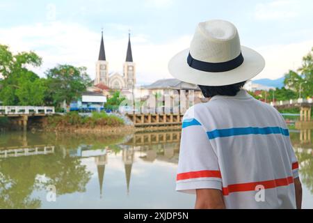Leute, die die Kathedrale der Unbefleckten Empfängnis von der Chantaboon Waterfront Community in Chanthaburi, Thailand, bewundern Stockfoto