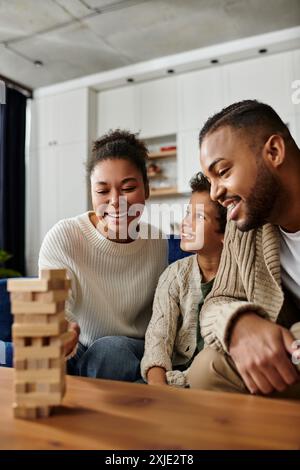 Glückliche afroamerikanische Familie, die ein gemeinsames Spiel auf der Couch genießt. Stockfoto