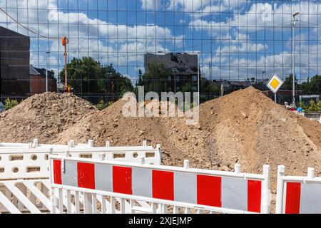 Baustellenbarrieren an der Bonner Straße, Glasfassade eines Bürogebäudes, Sandpfähle, Köln, Deutschland. Baustellenabsperrungen auf der Bonner S Stockfoto