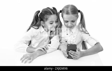 Schulkinder machen Selfie im Klassenzimmer. Zurück in die Schule. Mädchen, Kinder, die Selfie-Zeit haben. Schulfreunde bloggen und Selfie mit dem Telefon machen Stockfoto