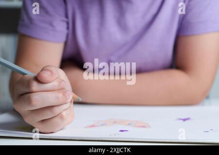 Hand hält einen farbigen Bleistift Stockfoto