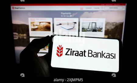 Stuttgart, Deutschland, 10.01.2022: Person, die ein Mobiltelefon mit dem Logo des türkischen Finanzdienstleisters Ziraat Bank auf dem Bildschirm vor der Webseite hält. Stockfoto