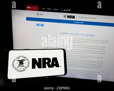 Stuttgart, Deutschland, 07.09.2023: Person, die ein Smartphone mit dem Logo der National Rifle Association of America (NRA) auf dem Bildschirm vor der Website hält. Stockfoto