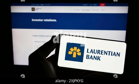 Stuttgart, Deutschland, 15.07.2023: Person, die ein Smartphone hält, mit dem Logo des Finanzunternehmens Laurentian Bank of Canada (LBC) vor dem Bildschirm Stockfoto
