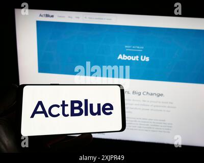 Stuttgart, 20.08.2023: Person mit Smartphone mit Logo der Fundraising-Organisation ActBlue Charities Inc. Auf dem Bildschirm vor der Website. Stockfoto