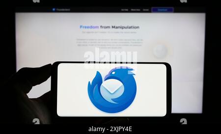 Stuttgart, 25.10.2023: Person mit Smartphone mit Logo des Open-Source-E-Mail-Clients Mozilla Thunderbird vor der Website. Konzentrieren Sie sich auf Stockfoto