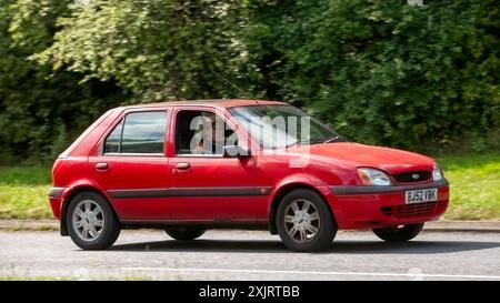 Milton Keynes, Großbritannien - 18. Juli 2024: 2002 roter Ford Fiesta Auto fährt auf einer britischen Landstraße Stockfoto