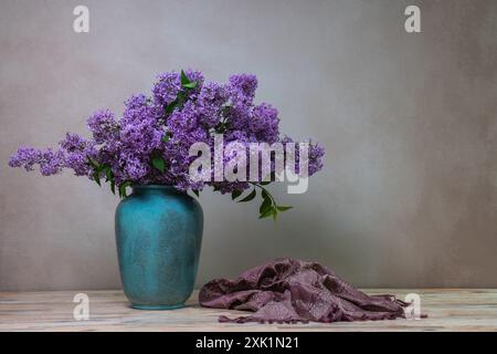 Ein riesiger Fliederstrauß in einer großen Vase, isoliert auf einem hellgrauen Hintergrund. Stillleben mit Blumen, viel Platz für Text Stockfoto